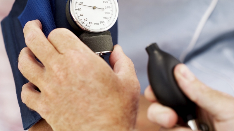 Pair of Human Hands Checking the Blood Pressure of a Patient